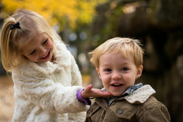 Girl Holding the Chin of Boy Outdoor