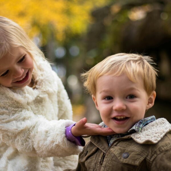 Girl Holding the Chin of Boy Outdoor