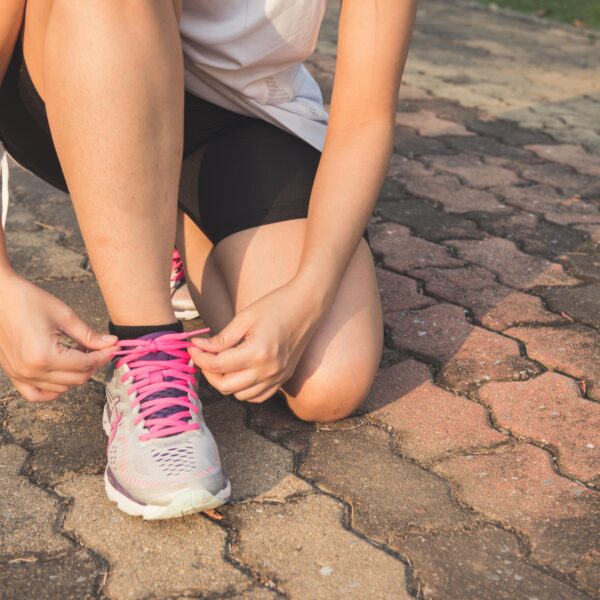 pexels-photo-601177-601177 Woman Lacing Up Her Gray and Pink Nike Low-top Athletic Shoe