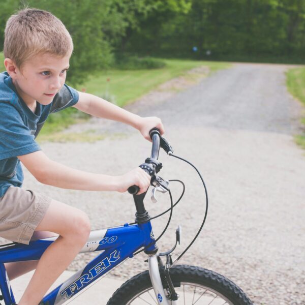 Boy Rides Blue Trek Bike at Daytime