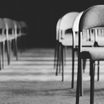 Grayscale Photo of Empty Folding Chairs