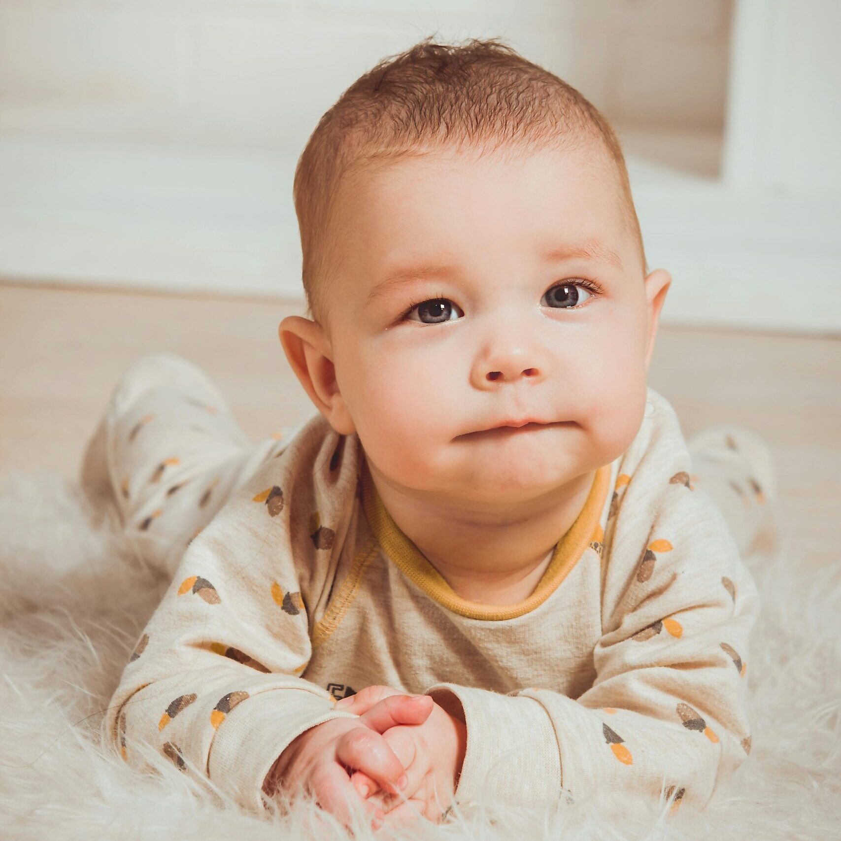 Photograph of a Baby Lying on Tummy