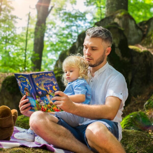 Photo Of Man And Child Reading Book During Daytime