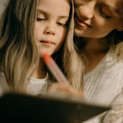 Girl Writing on the Paper Photograph