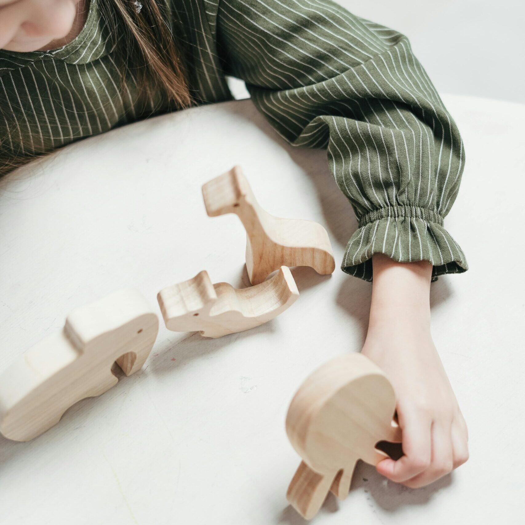 Girl Holding a Wooden Octopus