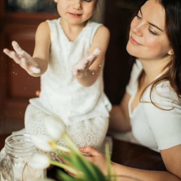 Photo of Woman Sitting Near Her Child