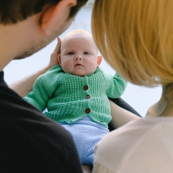 Man in Black Shirt Carrying Baby