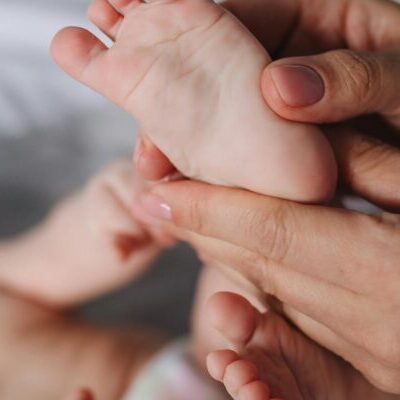 Person Holding Baby's Feet