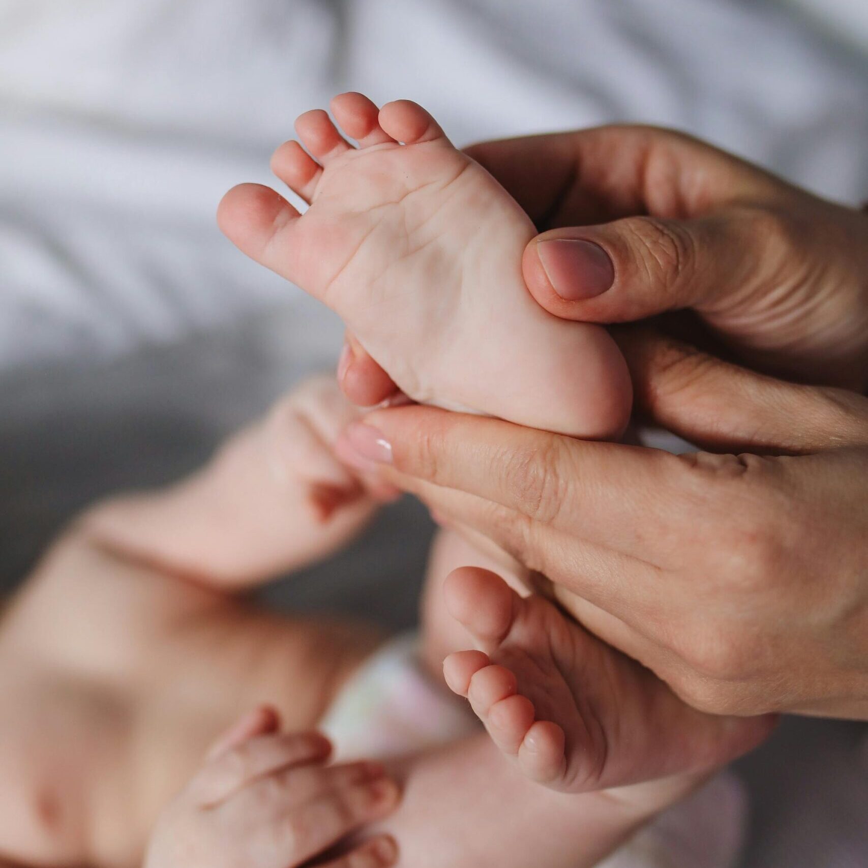 Person Holding Baby's Feet