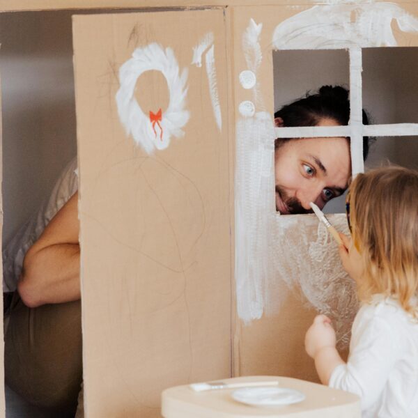 pexels-photo-3933259-3933259 A Little Girl and her Dad Painting a Cardboard House